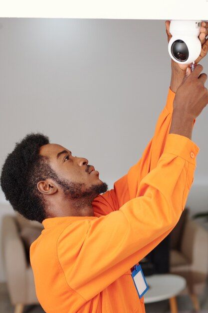 Technician installing CCTV camera